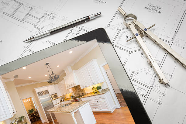 tablet with new kitchen laying on blue prints